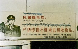 "Police Attention: No distributing any unhealthy thoughts or objects." A trilingual (Tibetan – Chinese – English) sign above the entrance to a small cafe in Nyalam, Tibet, 1993." From wikipedia.