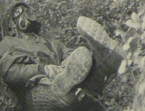 A soldier takes a rest break during Autumn Forge 83 (which included Able Archer 83) — in a gas mask. From Air Man.