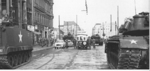 Tension mounted in late October 1961 when the Soviets mistakenly concluded that U.S. tanks deployed at Checkpoint Charlie signaled an effort to break through the wall. Moscow deployed 10 tanks which squared off with the U.S. tanks. Kennedy and Khrushchev privately defused the situation by agreeing that the Soviet tanks would withdraw first. (Photo source: U.S. National Archives, Army Signal Corps Collection, #111-SC-591491)