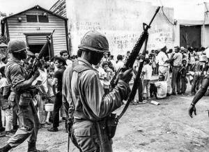 US troops patrol the streets near a food line in Santo Domingo on 5 May 1965 during the Dominican Crisis.